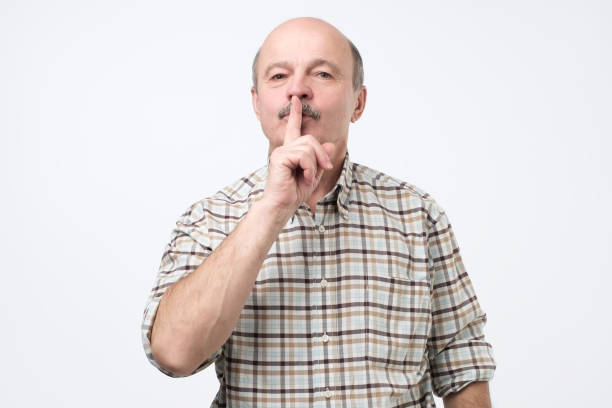 istock Senior man making silence gesture, keep it in secret 1079183720