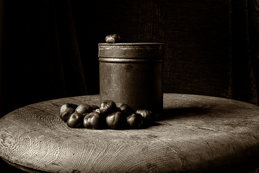 Old fashioned still life in sepia of chestnuts