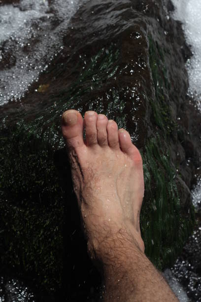 istock rocky feet, fingers and water 1079185884