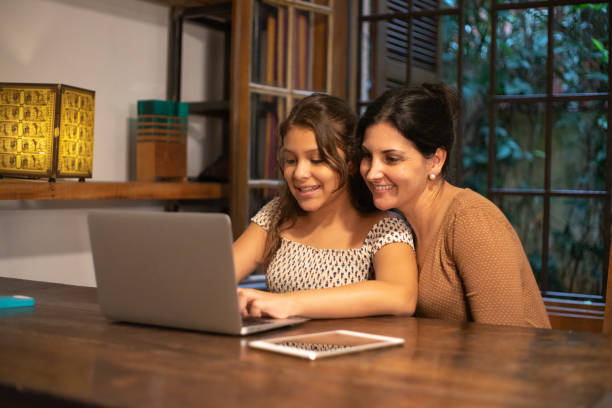 istock Girl using laptop with your mother at home 1079189990