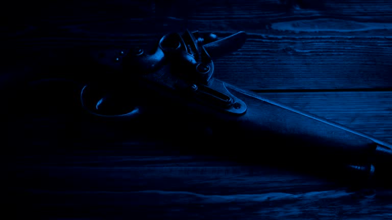 Old Pistol Gun On Table In The Dark