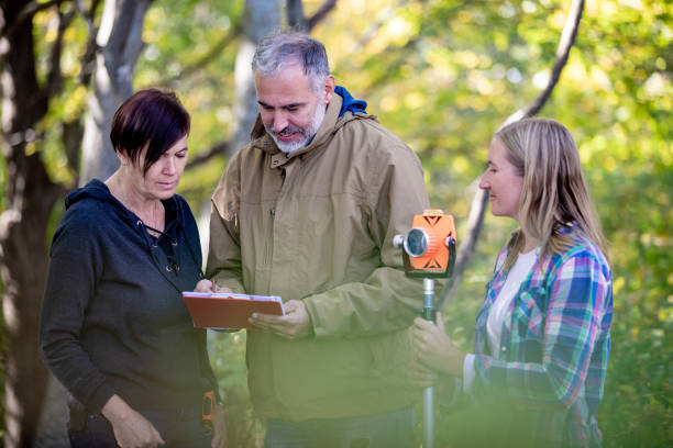 istock Surveyors and Customer Signing Agreement About Property Boundary 1079202342
