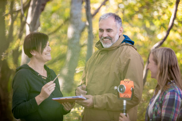 istock Surveyors and Customer Signing Agreement About Property Boundary 1079202348