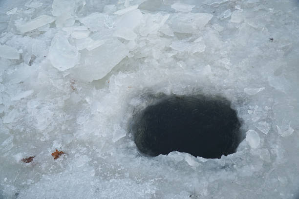 istock Ice hole in ice for winter fishing 1079217588