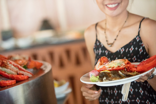 Close-up of unrecognizable woman seafood buffet
