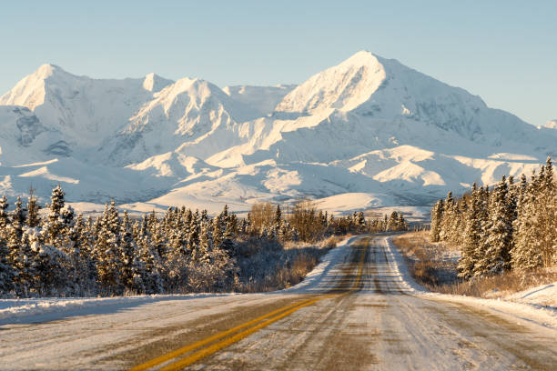 istock Alaska Remote Winter Highway with Mountains 1079237406