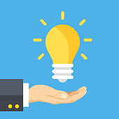 istock Hand holding lightbulb. Human hand and light bulb. Business solution, smart idea, startup, creativity, start up, innovation concepts. Modern flat design graphic elements. Vector illustration 1079243816
