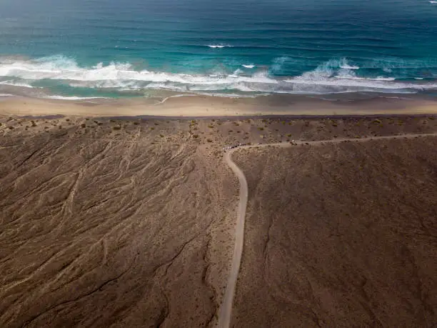 Photo of Aerial view of Famara beach, Lanzarote, Canary Islands, Spain. Unpaved road that runs along the coast