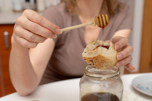 istock Tasty wheat roll on the kitchen table. Preparing dinner with fresh bread and honey. Autumn background. 1079246466