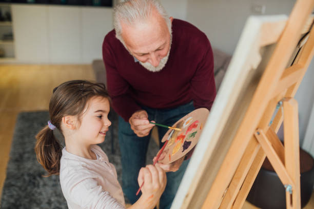 istock Man and girl painting 1079255582