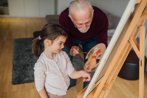 istock Man painting with a girl 1079256816