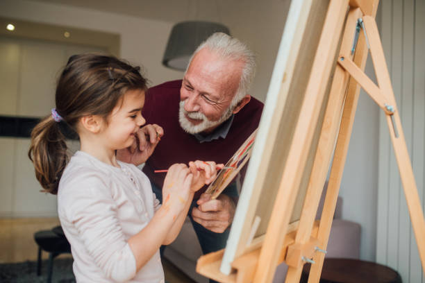 istock Man and granddaughter painting 1079256832