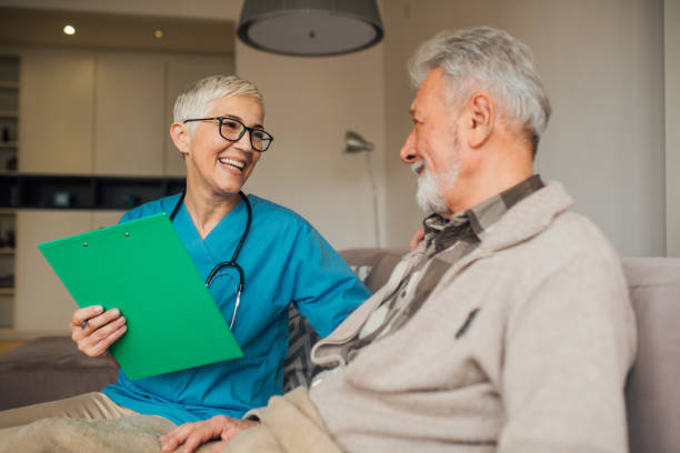 istock Smiling nurse at home visit 1079257470