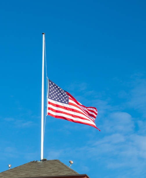 istock American flag flying at half staff 1079267598