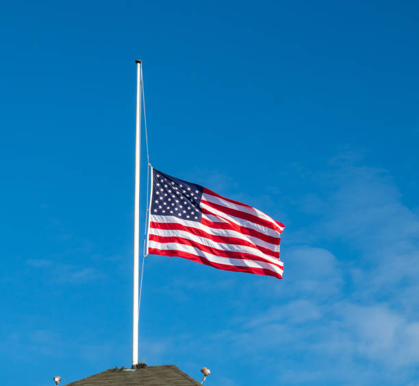 istock American flag flying at half staff 1079267648