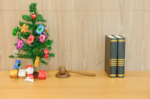 decorated christmas tree judge gavel & law book. lawyer attorney justice workplace at xmas new year holiday festival.