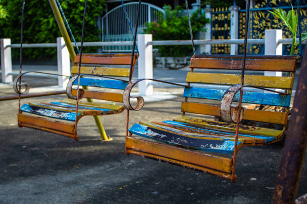 istock Swing chairs for children in park. 1079326464