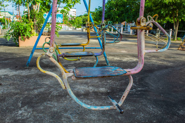 istock Swing chairs for children in park. 1079326528