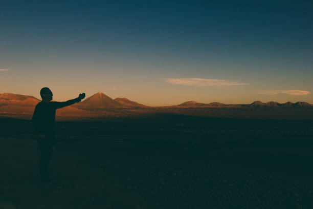 Young Caucasian woman looking at scenic view of lake in Atacama desert