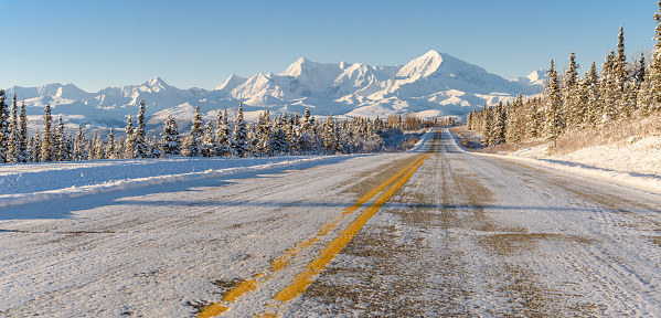 Remote Alaska Highway With Winter Mountain Panorama