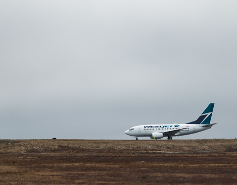 Goffs, Canada - January 12, 2018 - A Westjet flight taxis toward runway 23/05 at Halifax Stanfield International Airport. (YHZ)