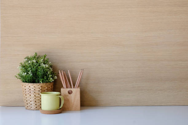 istock Copy space Mockup workspace with coffee, pencil and plant on desk and wood wall. 1079401800
