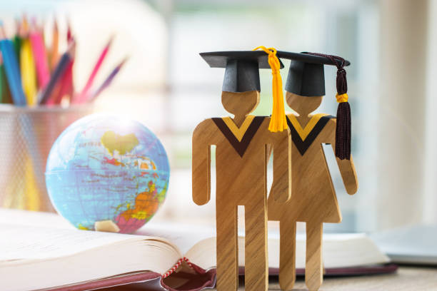 istock Australia Education knowledge learning study abroad international Ideas. People Sign wood with Graduation celebrating cap on open textbook with model global map, alternative studying world wide 1079411714