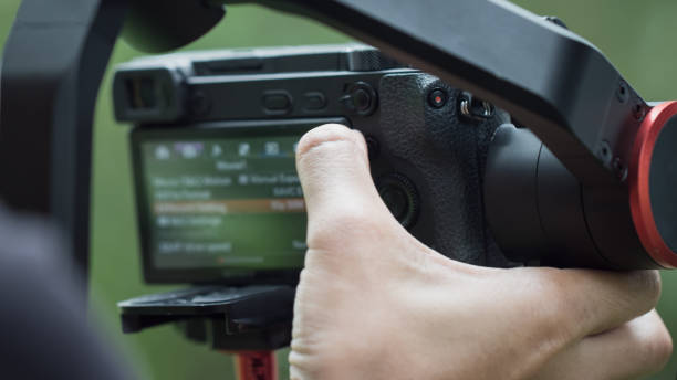 istock Video or professional digital mirrorless setting menu camera on tripod cran for recording taking photo at outdoor for live streaming event, movie production equipment. 1079413538