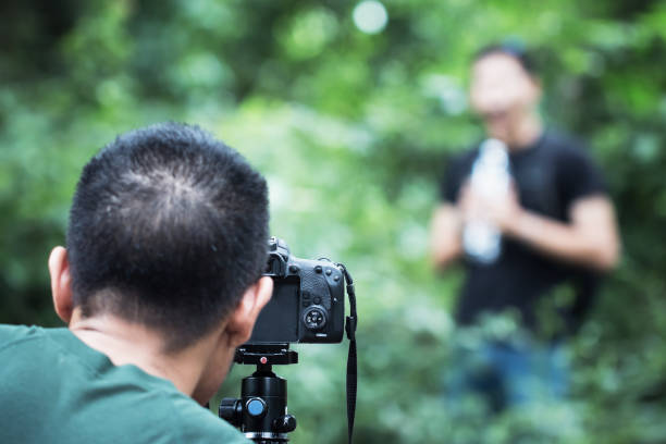 istock Young Asian cameraman set video camcorder interviews or professional digital mirrorless on tripod for camera recording tutorial vlog viral clip on live streaming about travel at outdoor 1079414626