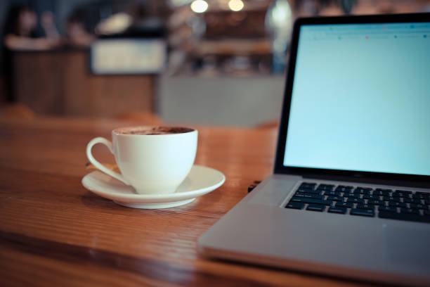 istock A cup of cappuccino coffee with laptop on table 1079421128