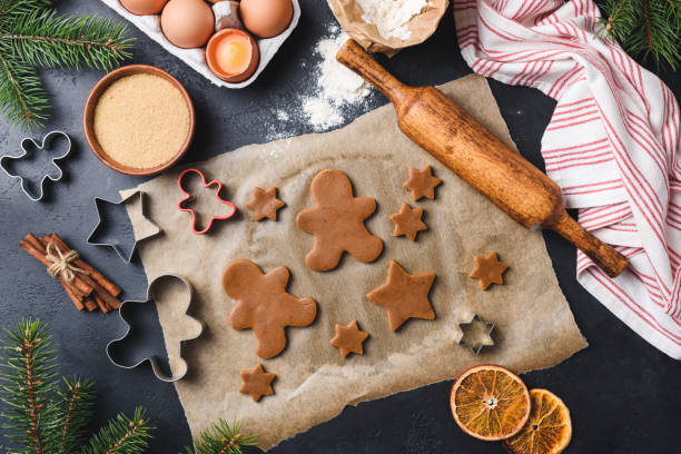 istock Preparation of gingerbread cookies on black concrete background 1079433400