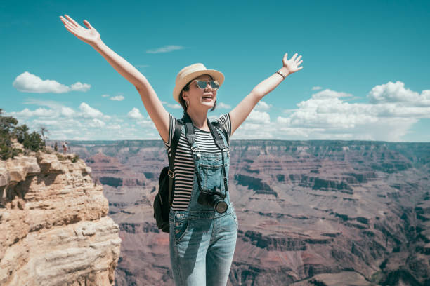istock carefree tourist raised hands to blue sky 1079444898