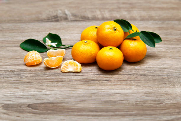 istock fresh oranges on wood texture background 1079446976