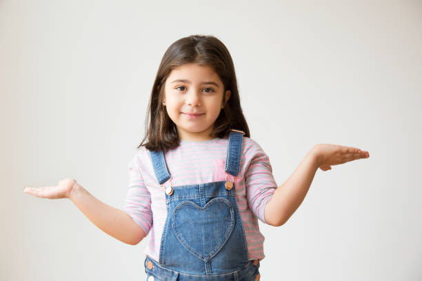 istock Cheerful Latin kid with shrug gesture asking something 1079447128