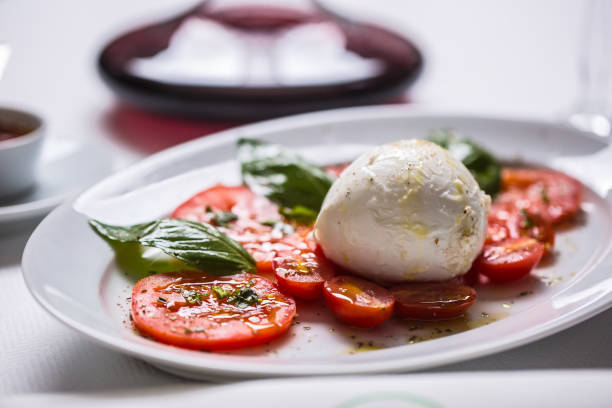 istock Caprese salad from mozzarella tomatoes basil olive oil an spices. 1079447204