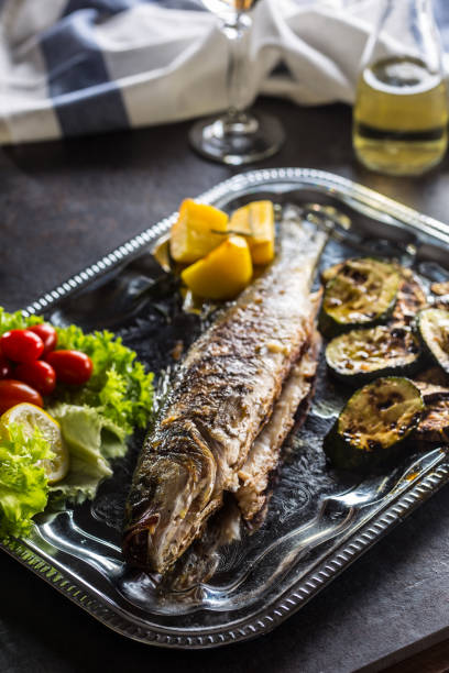 istock Roasted fish on dish with fresh and grilled vegetable. 1079447620