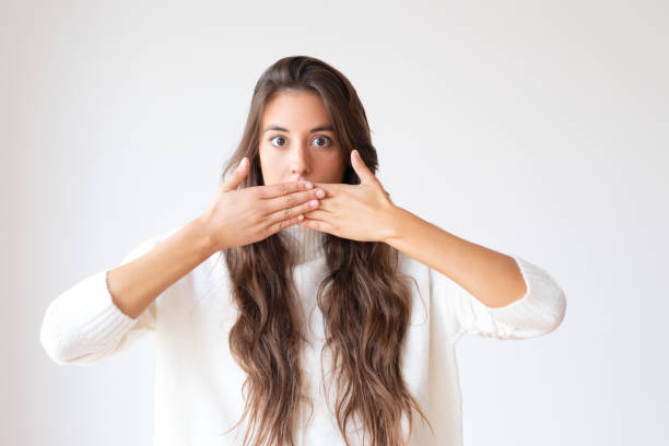 istock Attractive Latin girl closing mouth to keep silent 1079454984