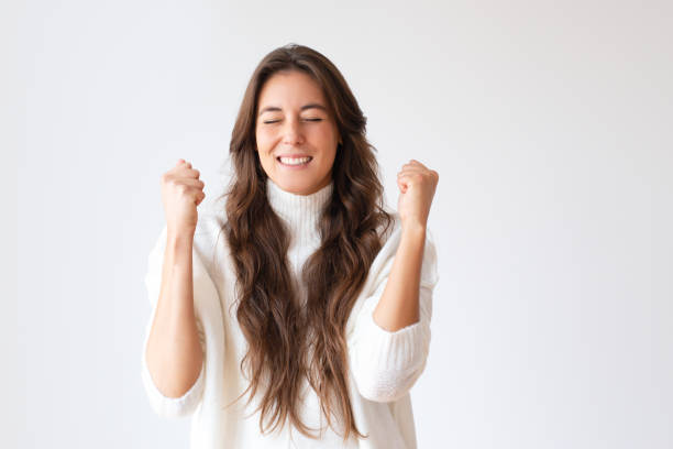 istock Beautiful cheerful winner triumphing with fists up 1079454996