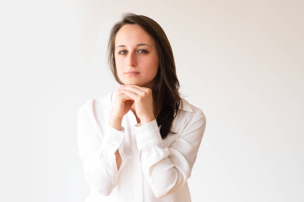 istock Pensive female student holding chin and looking at camera 1079455044