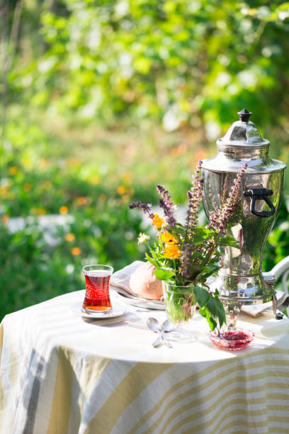 istock Black tea in pear shaped glass on table in garden under sunlight, summer outdoors, copy space 1079482688