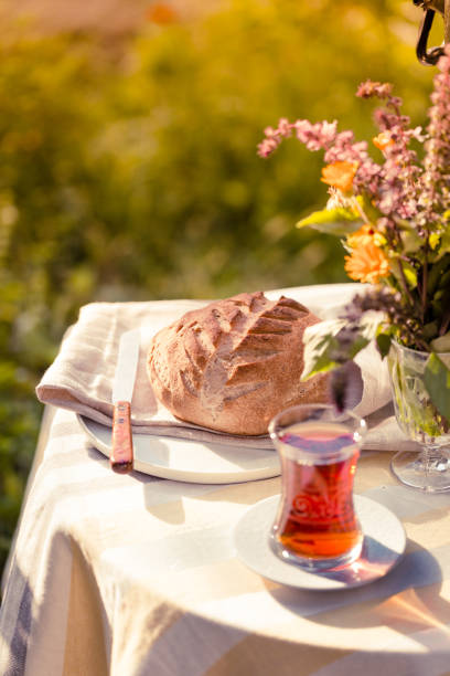 istock Tea set ceremony in garden setting, summer outdoors breakfast with fresh bread and rose jam and samovar 1079483272