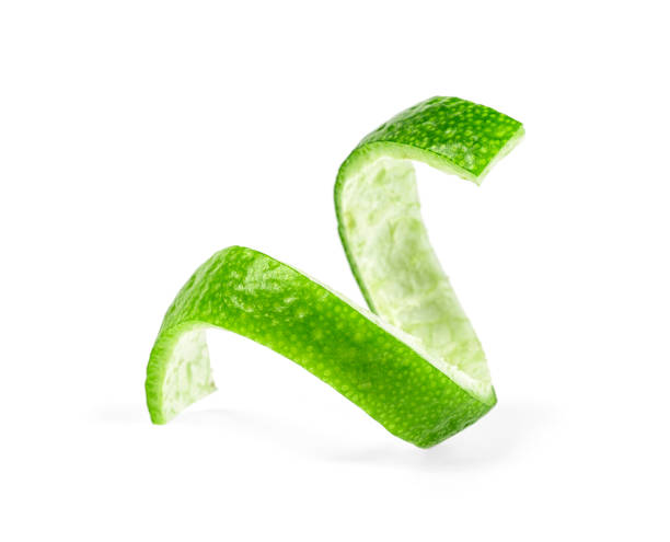Peel of lime over white background, closeup.