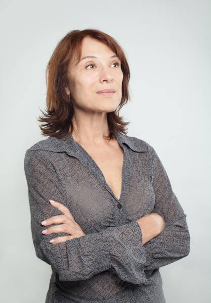 istock Confident business woman with crossed arms looking up on white background 1079507708