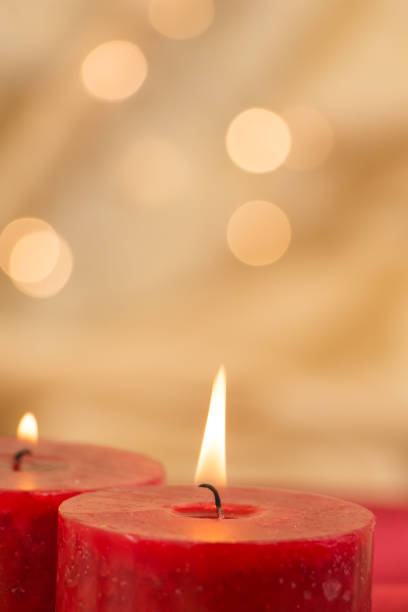 istock Lit red candles closeup and golden background with bokeh. 1079511150