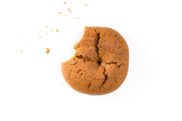 istock Bitten cookie with crumbs closeup, on white background. 1079511316