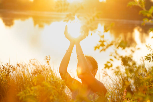 woman hands in mudra like in the palm of hands, at sunset  on the lake in nature - tibet india tibetan culture buddhism imagens e fotografias de stock