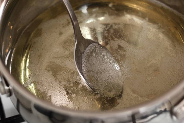 istock Boiling and Mixing Cider in Pan on Gas Stove. Making Cider Pie Series. 1079527076