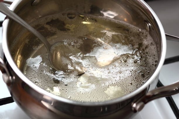 istock Boiling and Mixing Cider in Pan on Gas Stove. Making Cider Pie Series. 1079527180