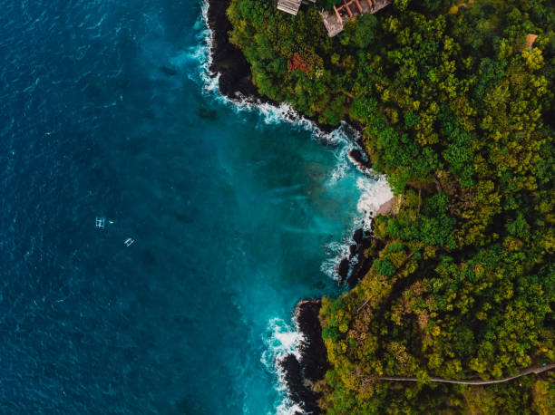 istock Blue ocean in tropics with rocky coastline. Aerial view. 1079528098