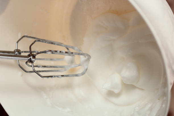 istock Whisking egg whites with handheld mixer. Making Cider Pie Series. 1079530240